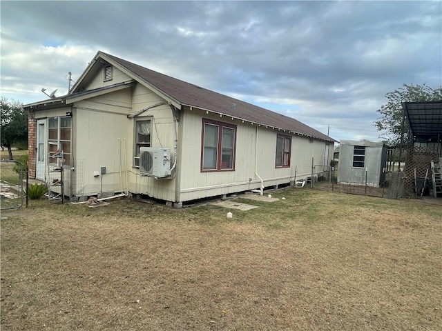 view of side of home with a lawn and cooling unit