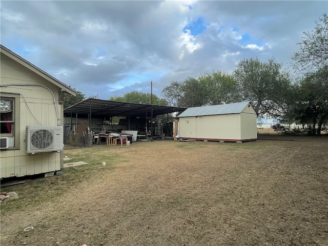 view of yard featuring a carport, ac unit, and a shed