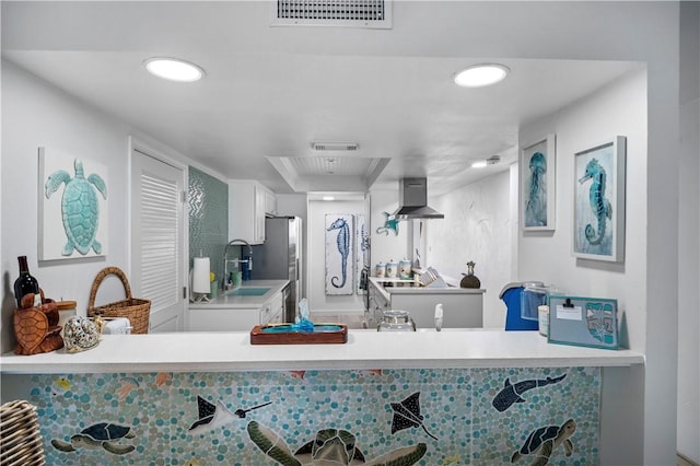 bathroom featuring visible vents and a sink