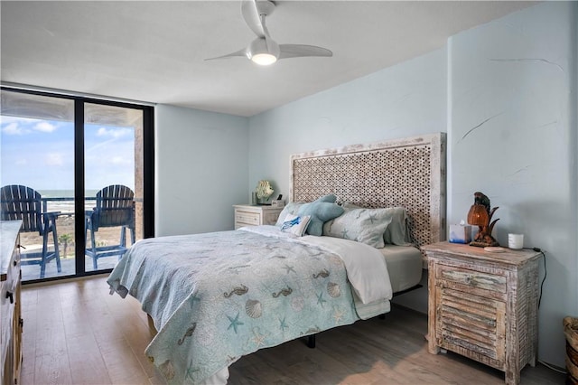 bedroom with a ceiling fan, access to outside, floor to ceiling windows, and wood finished floors