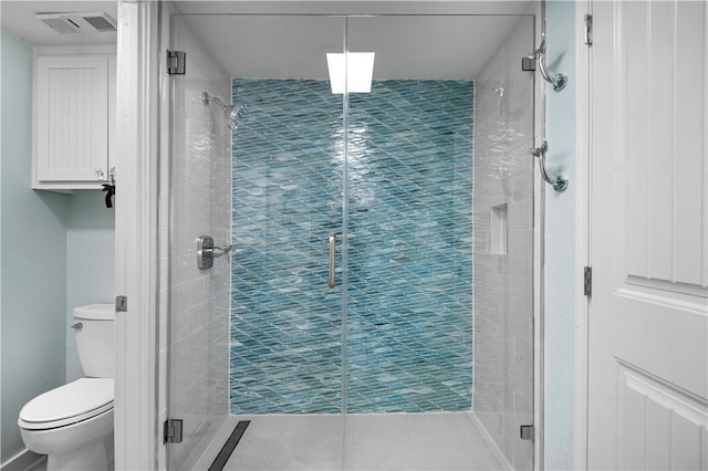 bathroom with visible vents, a shower stall, and toilet