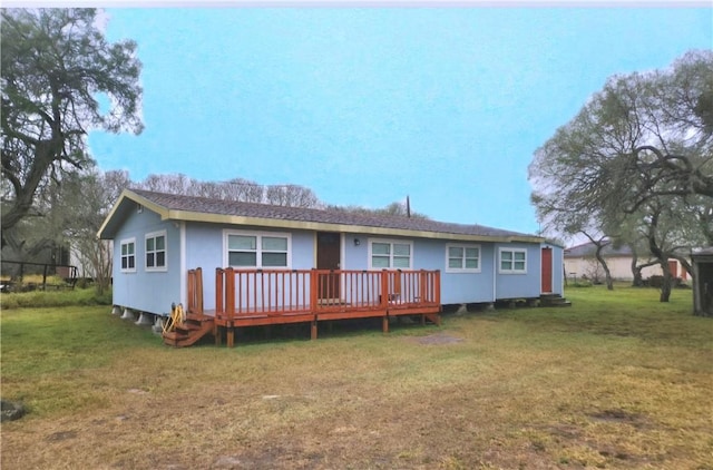 rear view of house featuring a lawn and a wooden deck