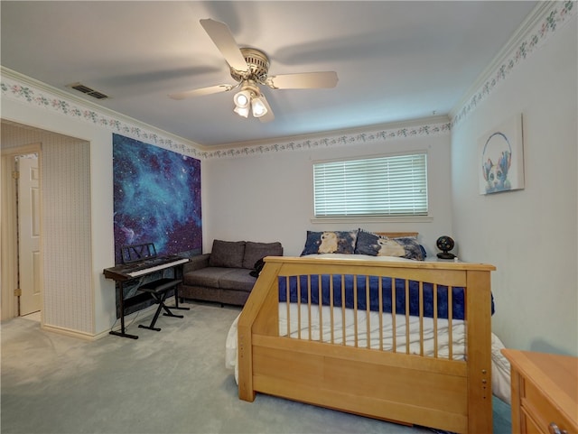 carpeted bedroom with ceiling fan and crown molding