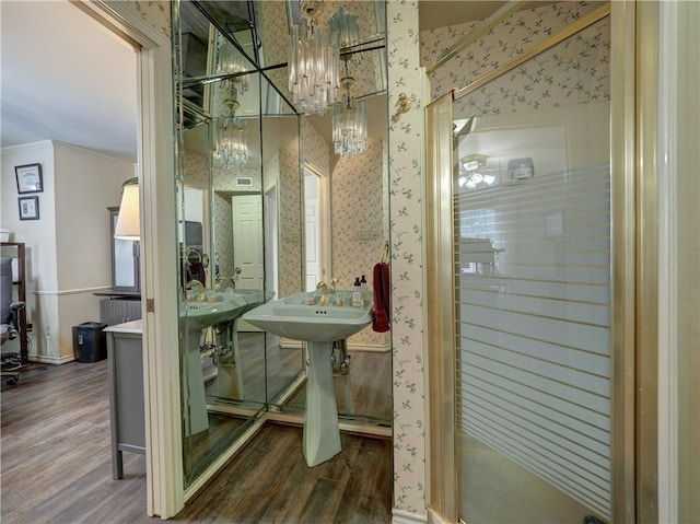 bathroom featuring hardwood / wood-style floors and a chandelier