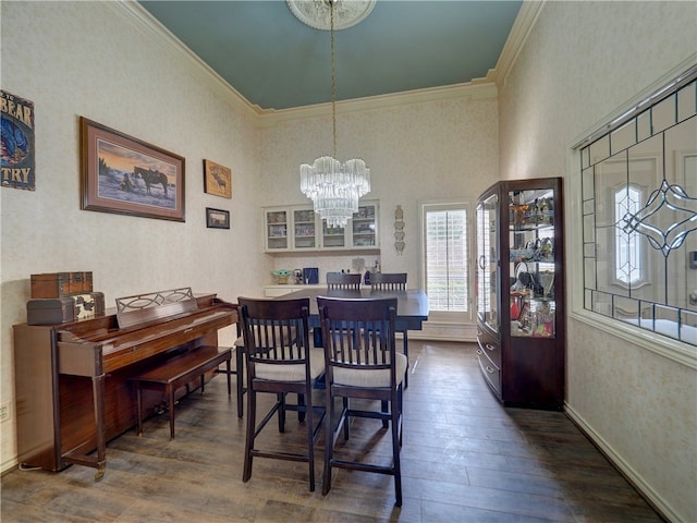 dining space with crown molding, dark hardwood / wood-style floors, and a chandelier