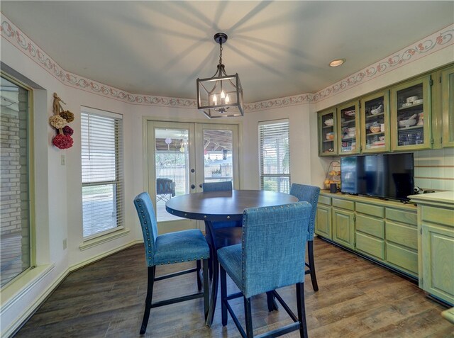 dining room with hardwood / wood-style floors, a chandelier, and french doors