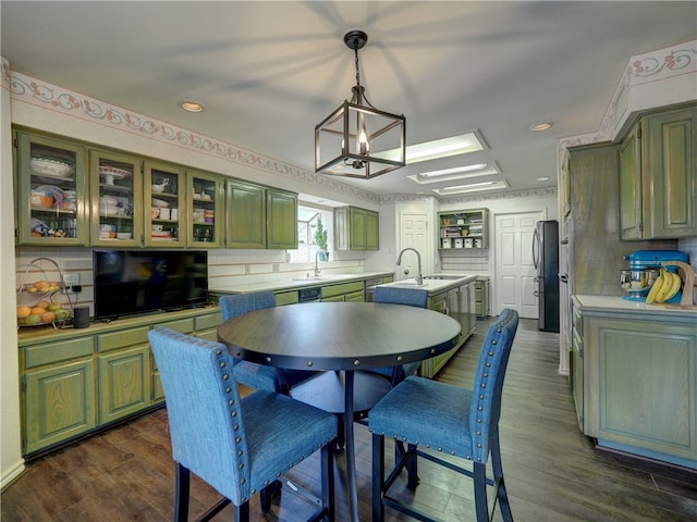 kitchen with dark hardwood / wood-style floors, sink, stainless steel refrigerator, and backsplash