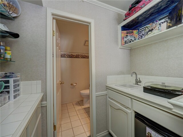 bathroom featuring ornamental molding, tile patterned flooring, vanity, and toilet