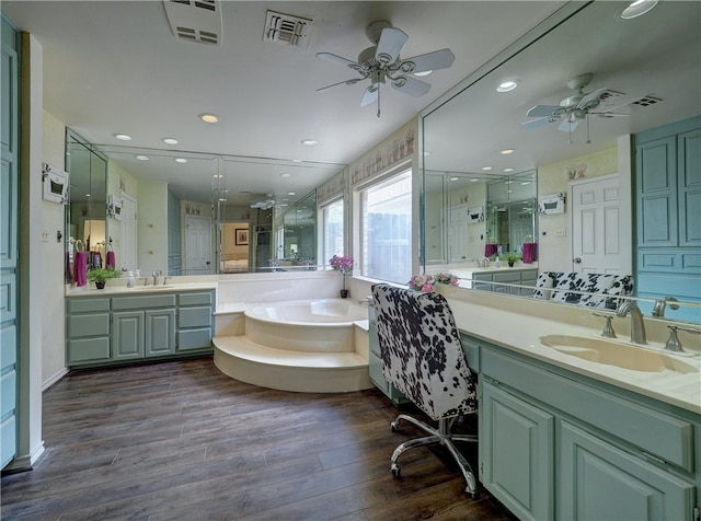 bathroom with vanity, plus walk in shower, hardwood / wood-style flooring, and ceiling fan