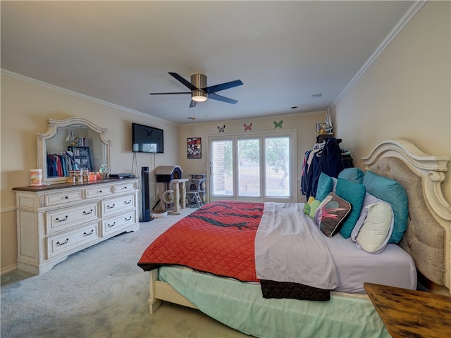 bedroom featuring ornamental molding, light carpet, and ceiling fan