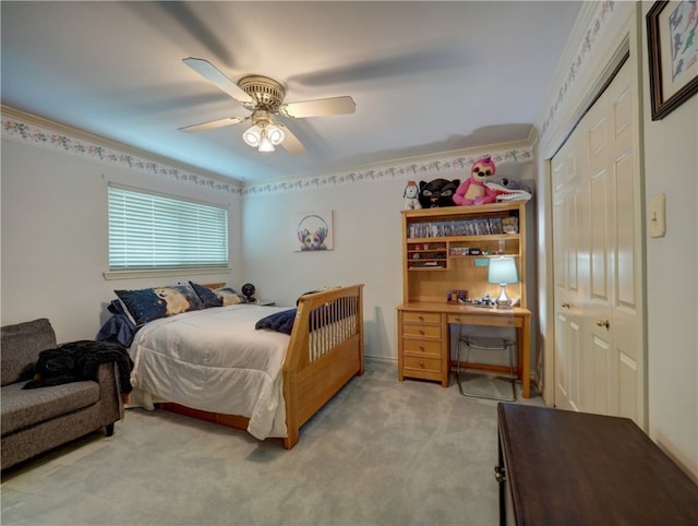 bedroom featuring light carpet, ceiling fan, crown molding, and a closet