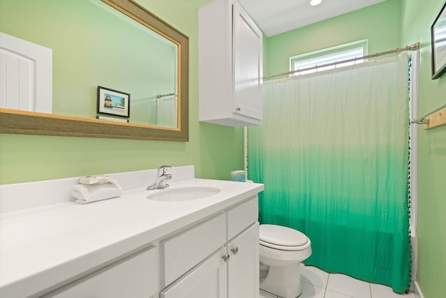 bathroom featuring toilet, vanity, tile patterned floors, and curtained shower