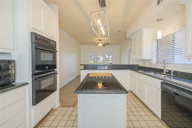 505 Spyglass St, Rockport, TX 78382 - kitchen featuring a sink, white cabinetry, a center island, black appliances, and pendant lighting