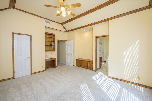 505 Spyglass St, Rockport, TX 78382 - unfurnished bedroom featuring light carpet, visible vents, built in study area, ornamental molding, and vaulted ceiling
