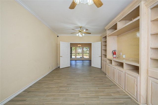 505 Spyglass St, Rockport, TX 78382 - interior space featuring ceiling fan with notable chandelier, ornamental molding, baseboards, and light wood-style floors