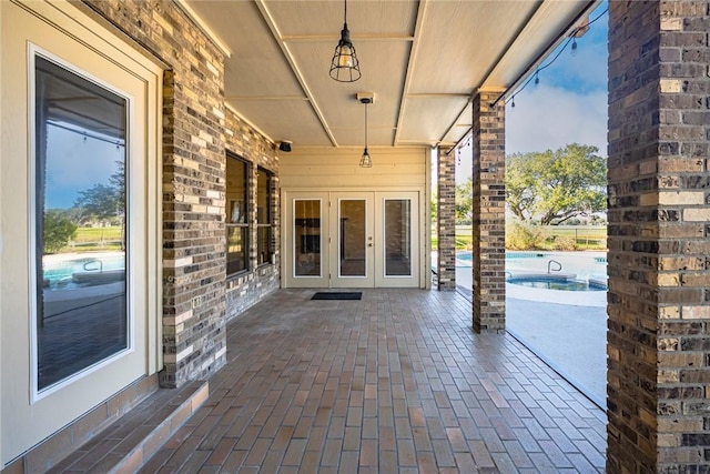 505 Spyglass St, Rockport, TX 78382 - view of patio / terrace with french doors and an outdoor pool