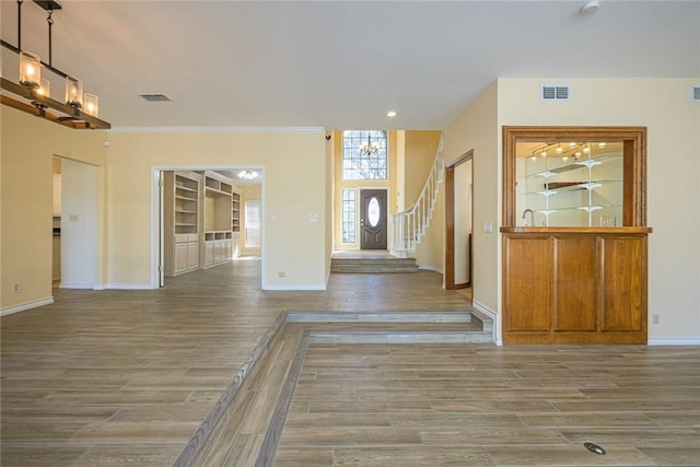505 Spyglass St, Rockport, TX 78382 - foyer featuring visible vents, stairway, baseboards, and wood finished floors