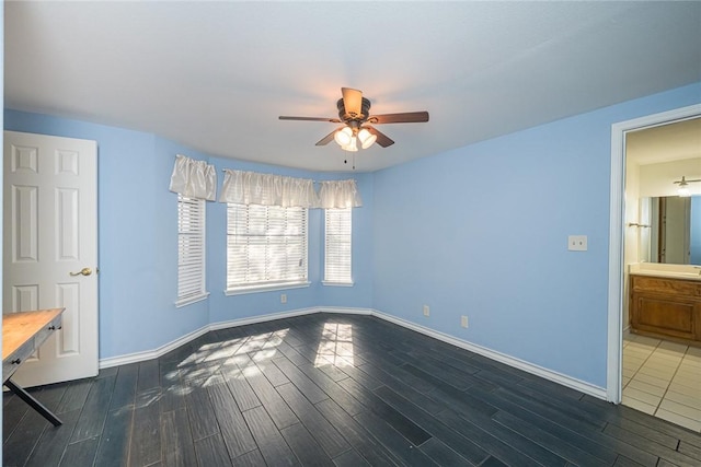 505 Spyglass St, Rockport, TX 78382 - unfurnished bedroom featuring dark wood-style floors, baseboards, and a ceiling fan