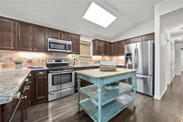 kitchen with stainless steel appliances, dark brown cabinets, lofted ceiling, dark wood-style floors, and tasteful backsplash