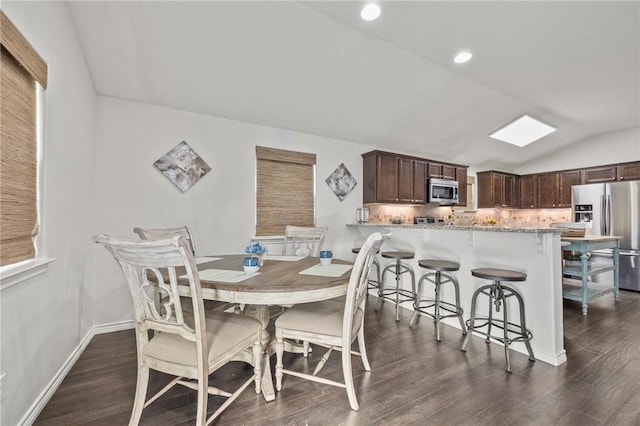 dining space featuring dark wood-type flooring, lofted ceiling, baseboards, and recessed lighting