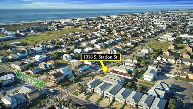 aerial view of property's location with nearby suburban area and a large body of water