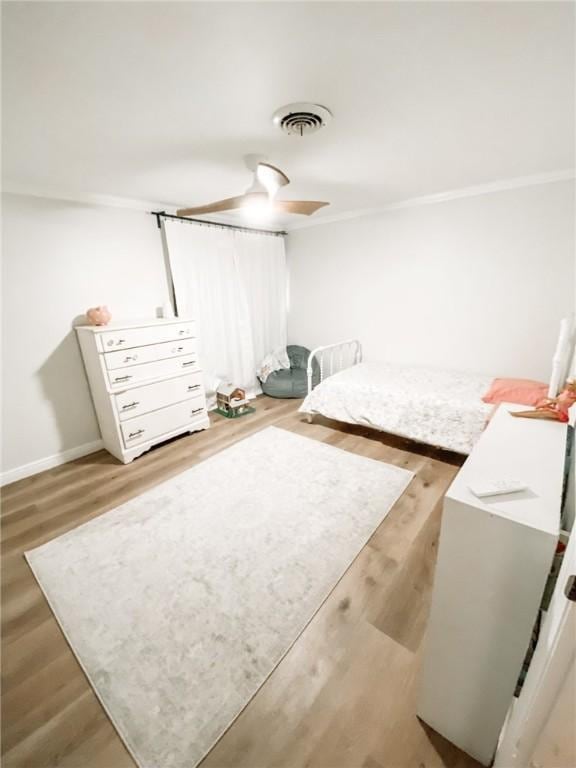 1801 Clare Dr, Alice, TX 78332 - bedroom with wood finished floors, baseboards, a ceiling fan, and crown molding