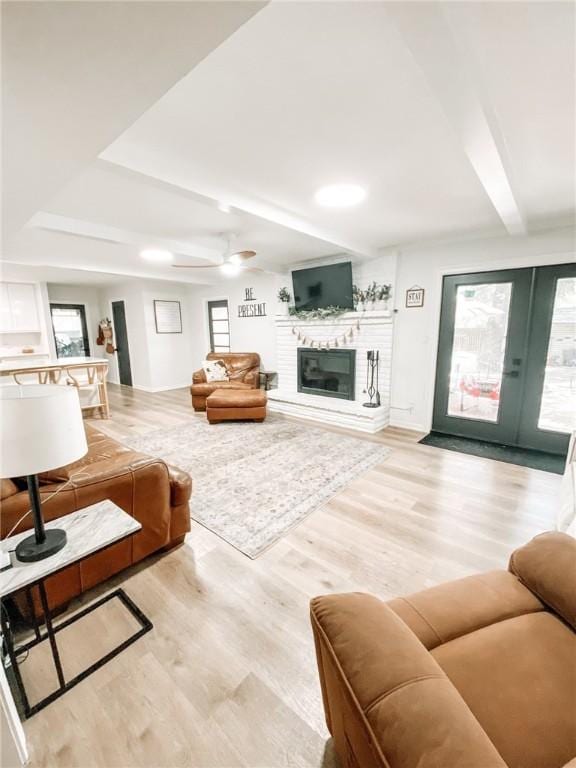 1801 Clare Dr, Alice, TX 78332 - living area with light wood-type flooring, a fireplace, a ceiling fan, and beamed ceiling