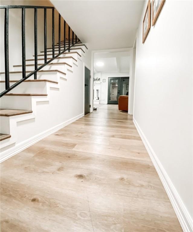 1801 Clare Dr, Alice, TX 78332 - foyer featuring stairway, wood finished floors, and baseboards