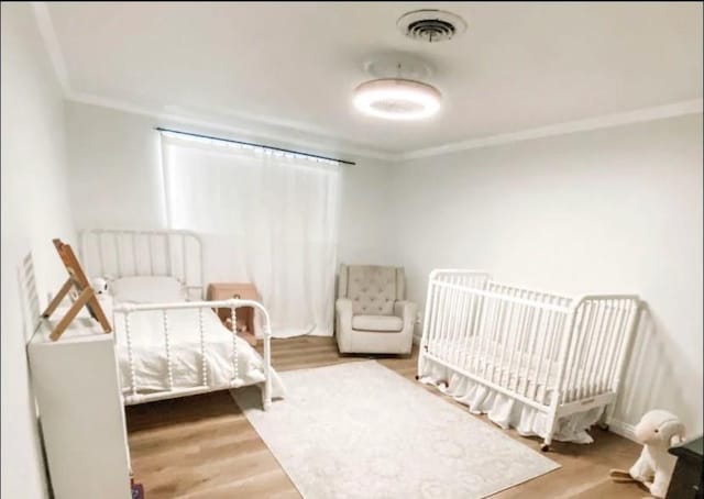 1801 Clare Dr, Alice, TX 78332 - bedroom featuring crown molding and wood finished floors