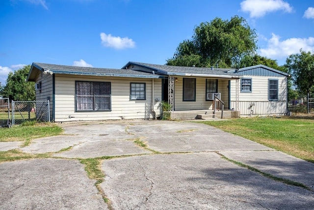 ranch-style home with a porch and a front yard