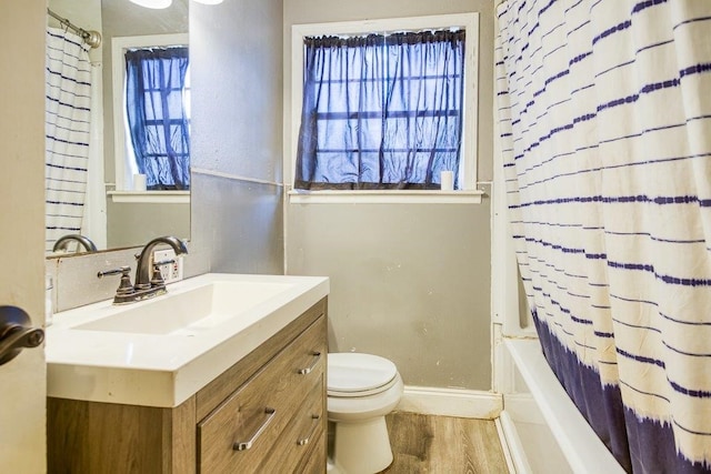 full bathroom with shower / bathtub combination with curtain, wood-type flooring, toilet, and vanity