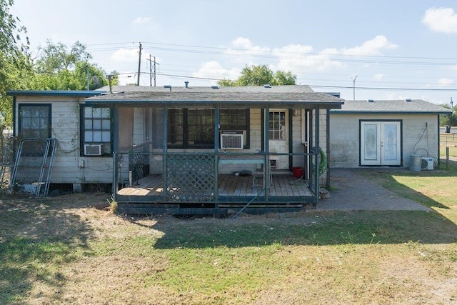 back of property with cooling unit, a lawn, and a deck