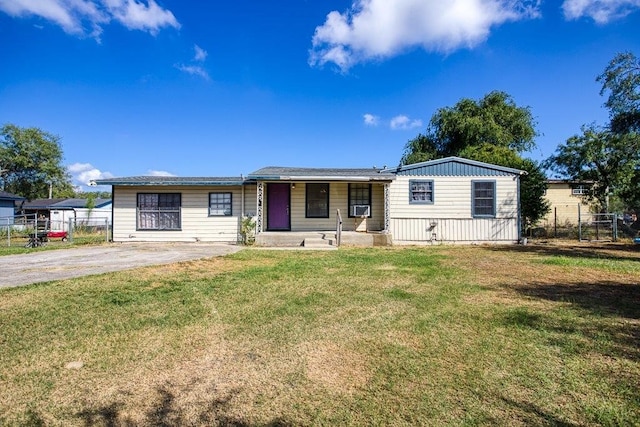 view of front of house with a front lawn and cooling unit