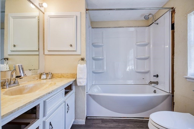 full bathroom featuring vanity, hardwood / wood-style flooring, toilet, and shower / bathtub combination