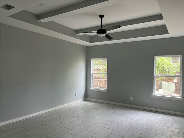 empty room with ceiling fan and beam ceiling