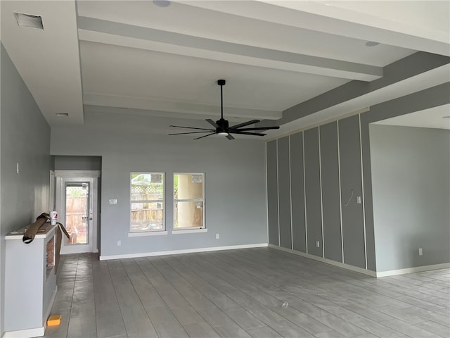 unfurnished living room featuring ceiling fan, light hardwood / wood-style floors, and beamed ceiling