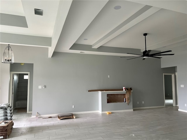 unfurnished living room featuring ceiling fan, beam ceiling, and light wood-type flooring