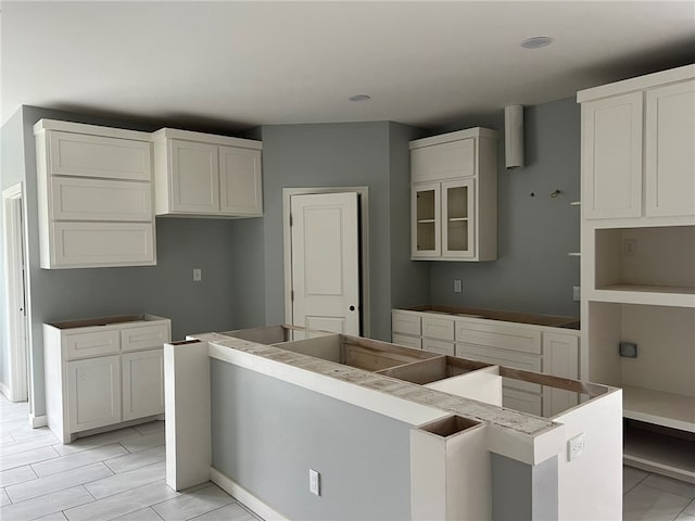 kitchen featuring white cabinets and a center island