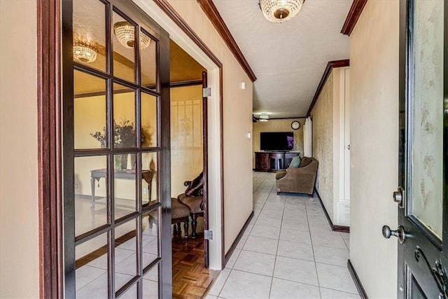 hallway with french doors, light parquet flooring, and ornamental molding