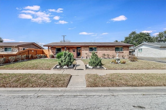 ranch-style home with a front lawn