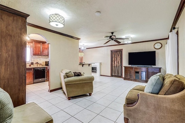 tiled living room with crown molding, a textured ceiling, and ceiling fan