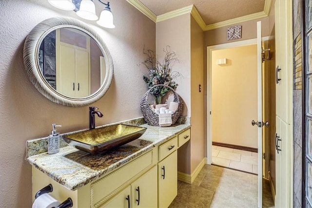 bathroom with vanity, crown molding, tile patterned floors, and a textured ceiling