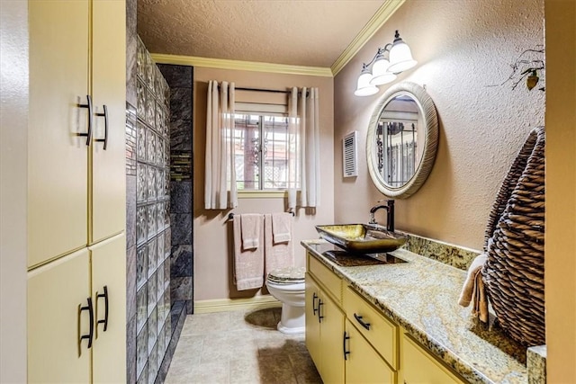 bathroom featuring vanity, ornamental molding, a shower, a textured ceiling, and toilet