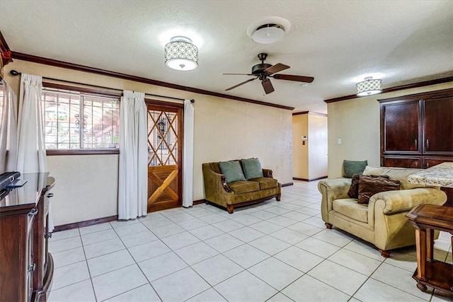 tiled living room with ceiling fan, ornamental molding, and a textured ceiling