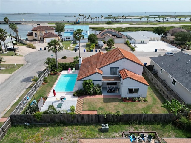 birds eye view of property with a water view and a residential view