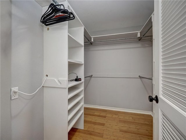 spacious closet with wood finished floors