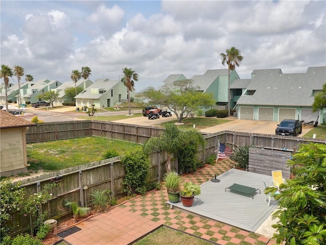 view of yard with a residential view, a fenced backyard, and a wooden deck
