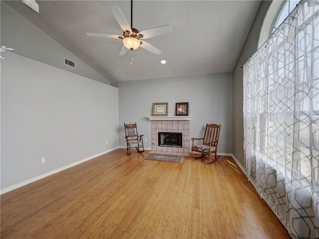 sitting room featuring ceiling fan, vaulted ceiling, light wood-style flooring, and visible vents