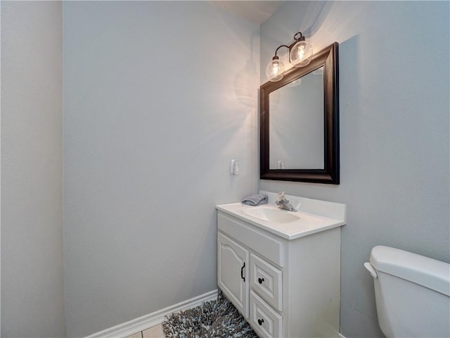 half bathroom with vanity and toilet