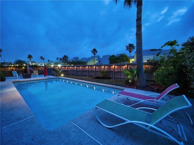 view of swimming pool featuring a fenced in pool, a fenced backyard, and a patio area